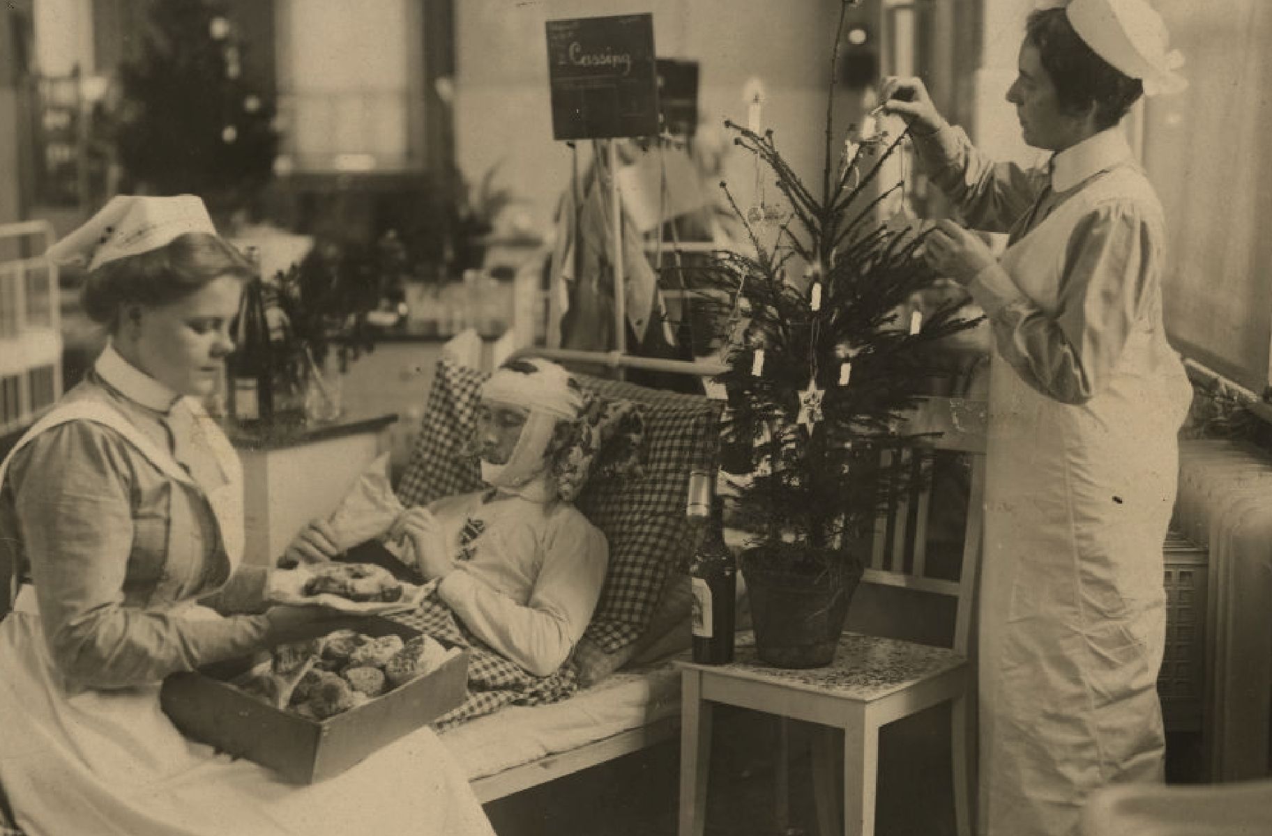 Black and white image of nurses looking after war patient 