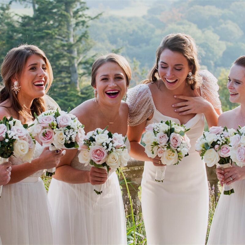 bride and bridesmaids laughing