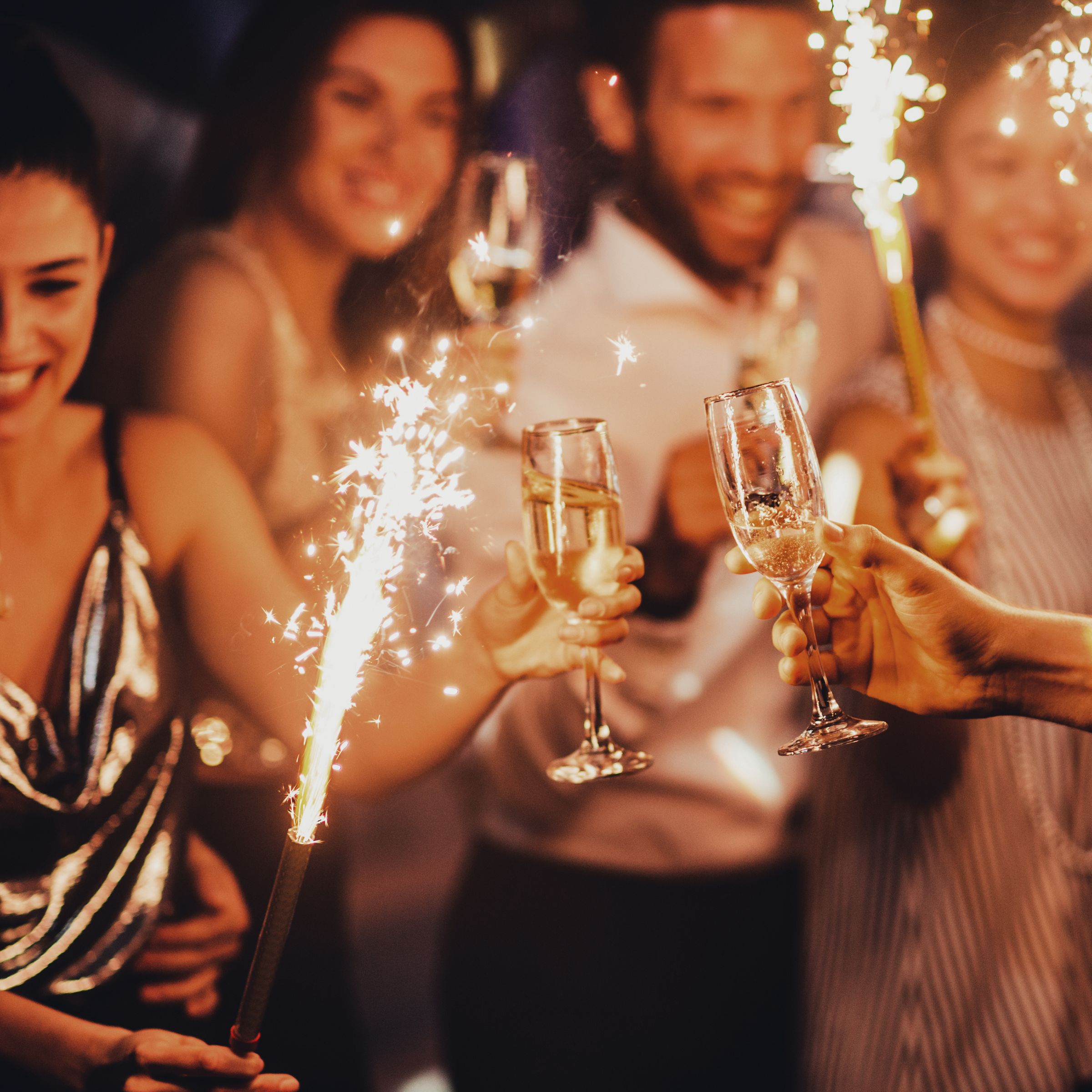 Group celebrating with sparklers and champagne