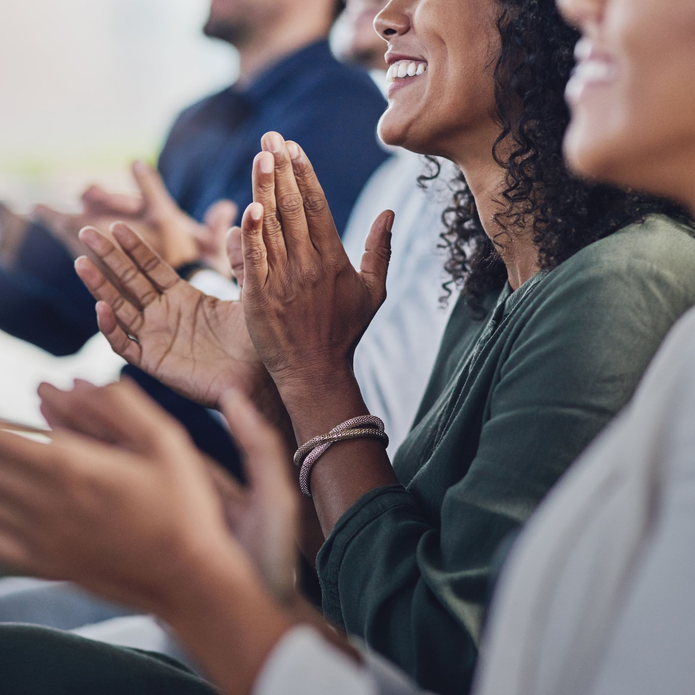 People smiling and clapping 