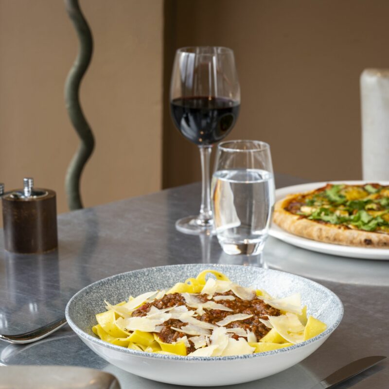 plates of food with glass of water and red wine