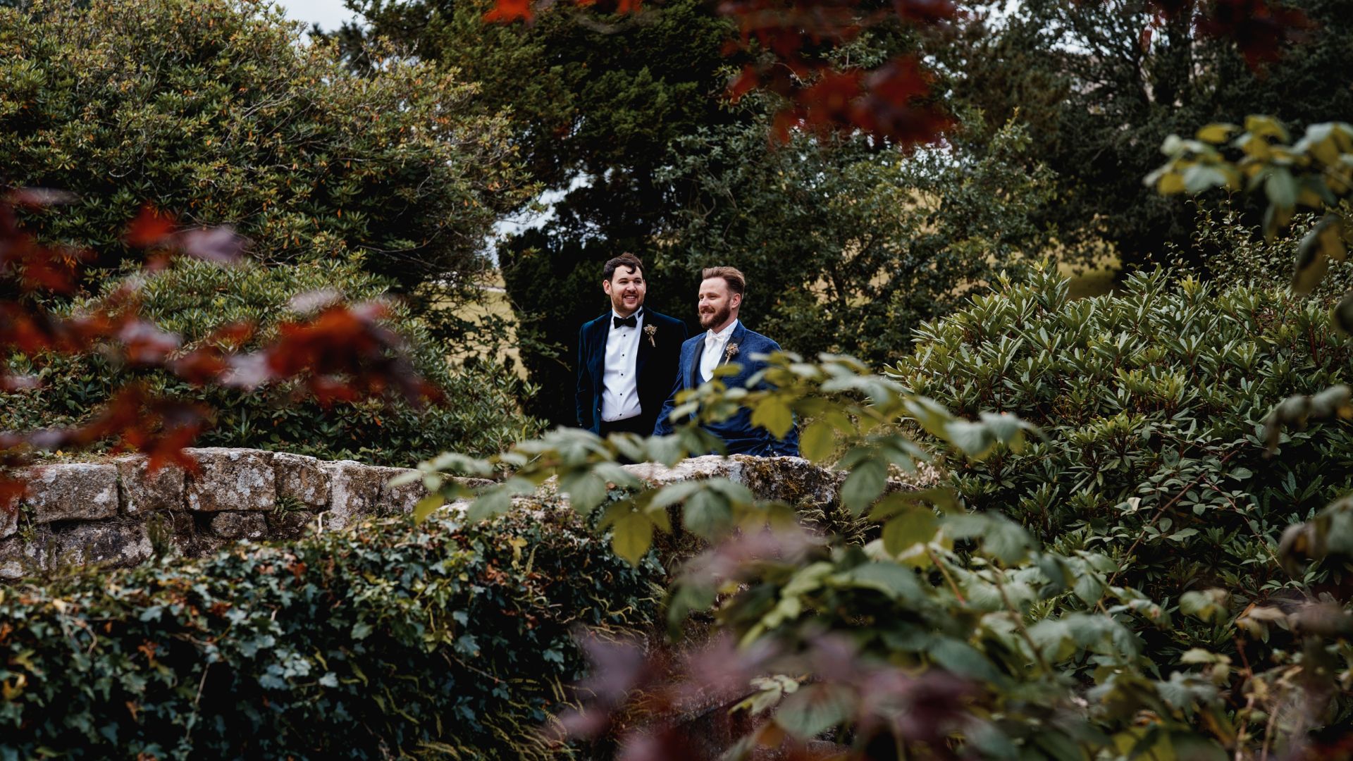 Married men walking through Bovey Castle grounds 