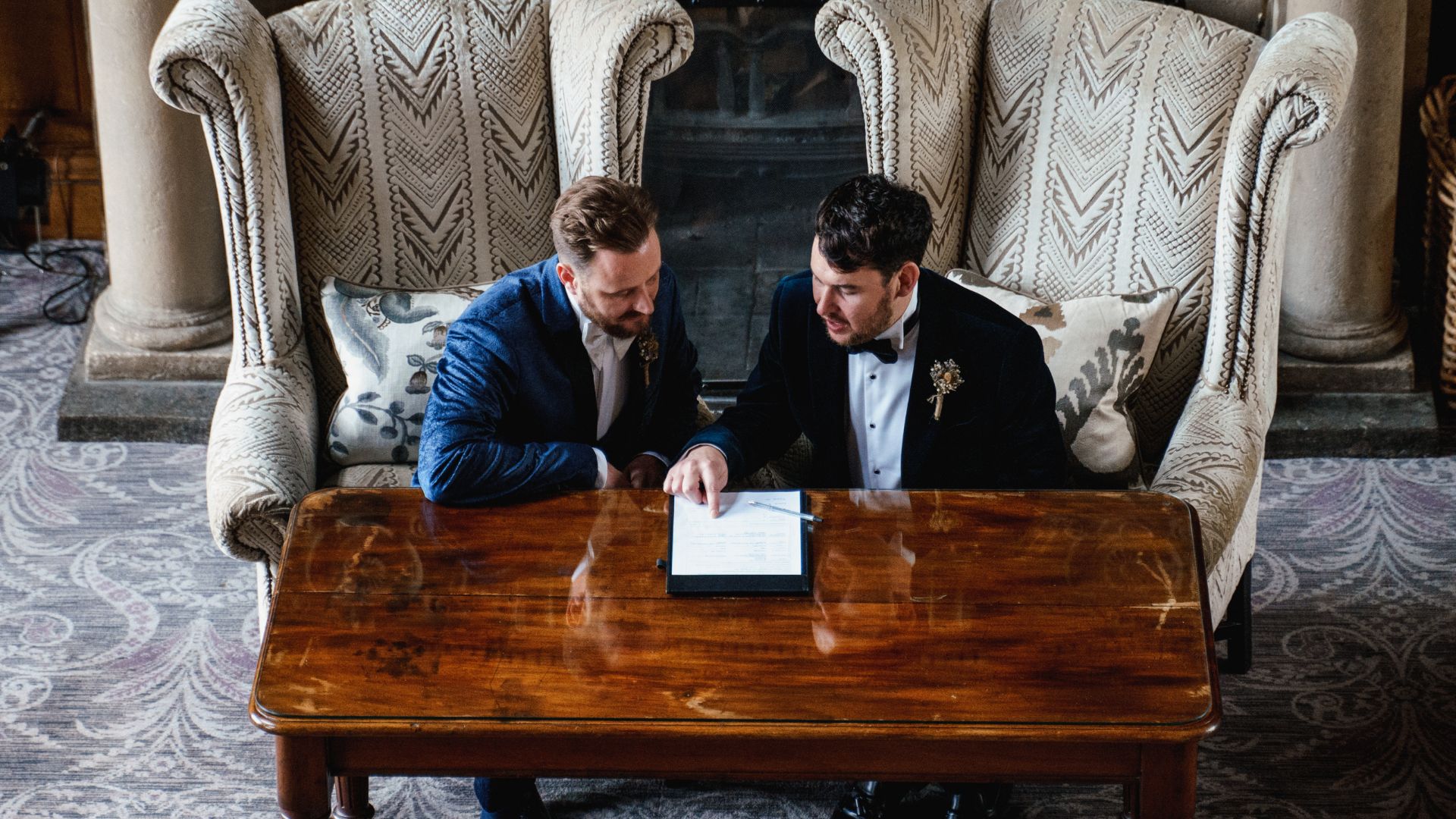 Married men reviewing marriage certificate