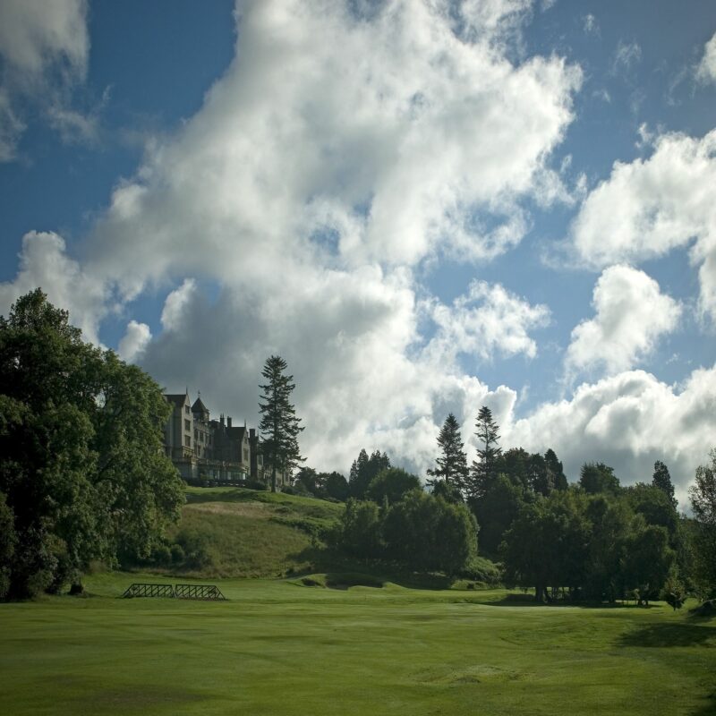 Long distance view of golf course with castle in the background