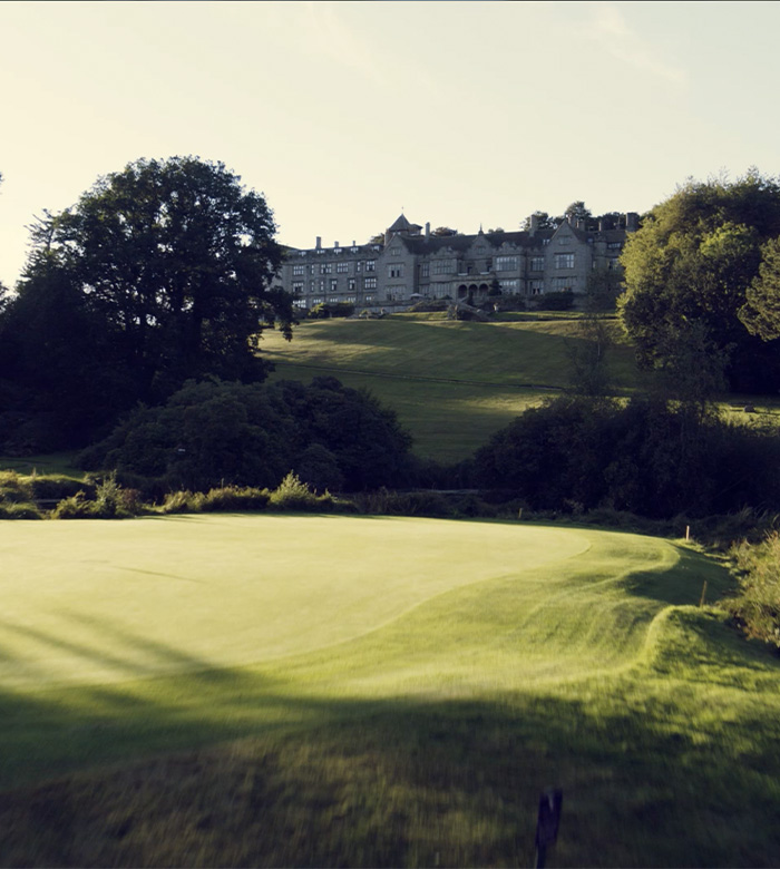 birds eye view of bovey golf course with castle in background 