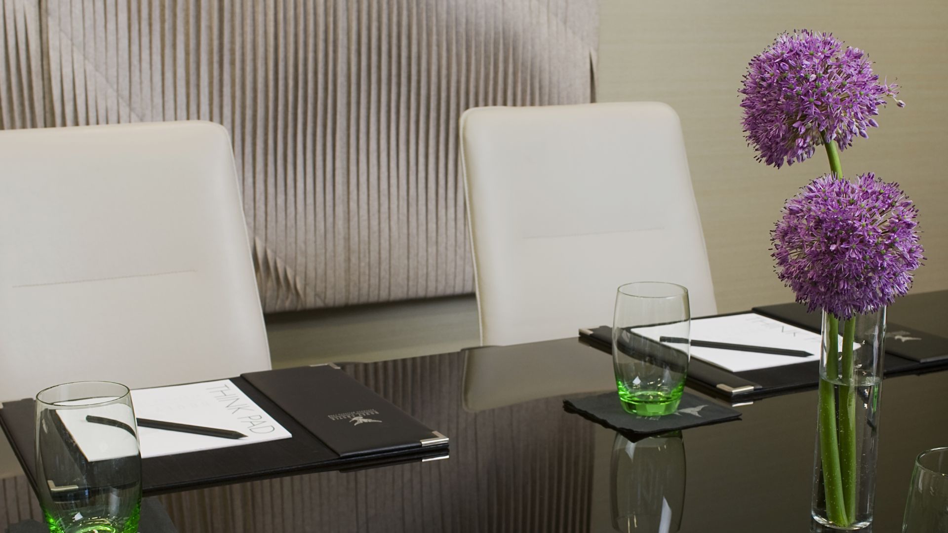 boardroom with table, notepad and flowers 