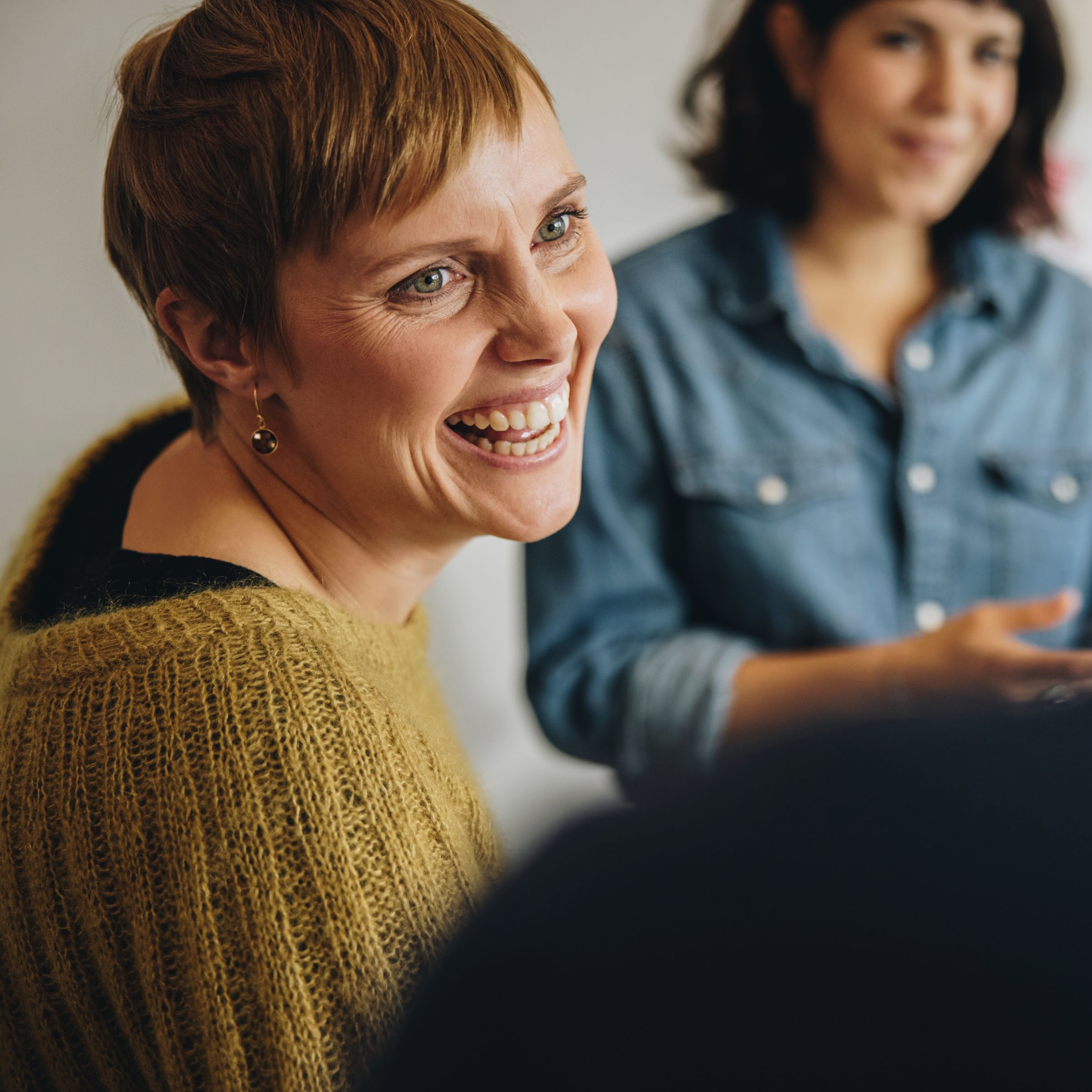 woman smiling with colleagues 