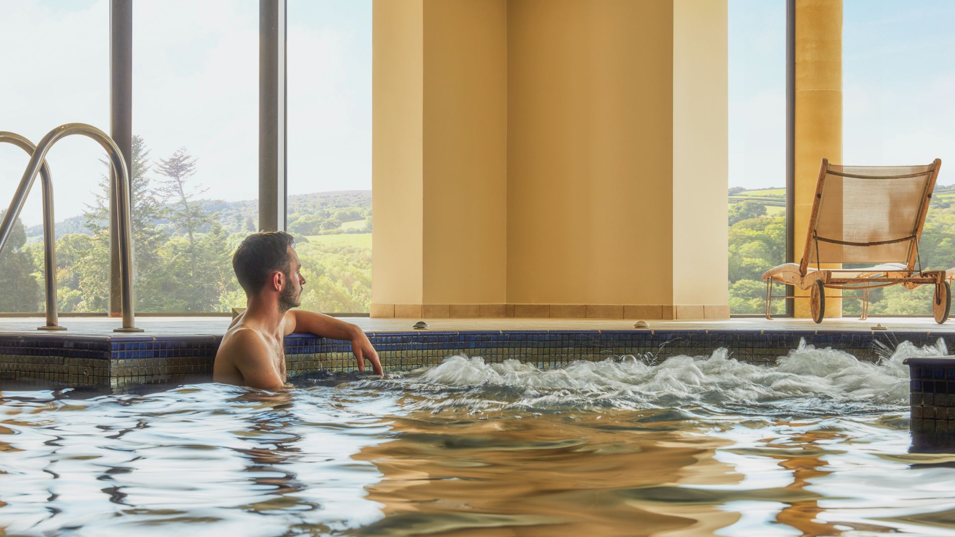 Man relaxing in pool with bubbles 