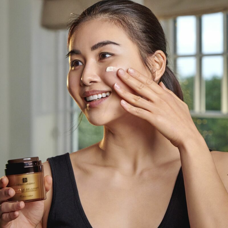 woman applying face cream