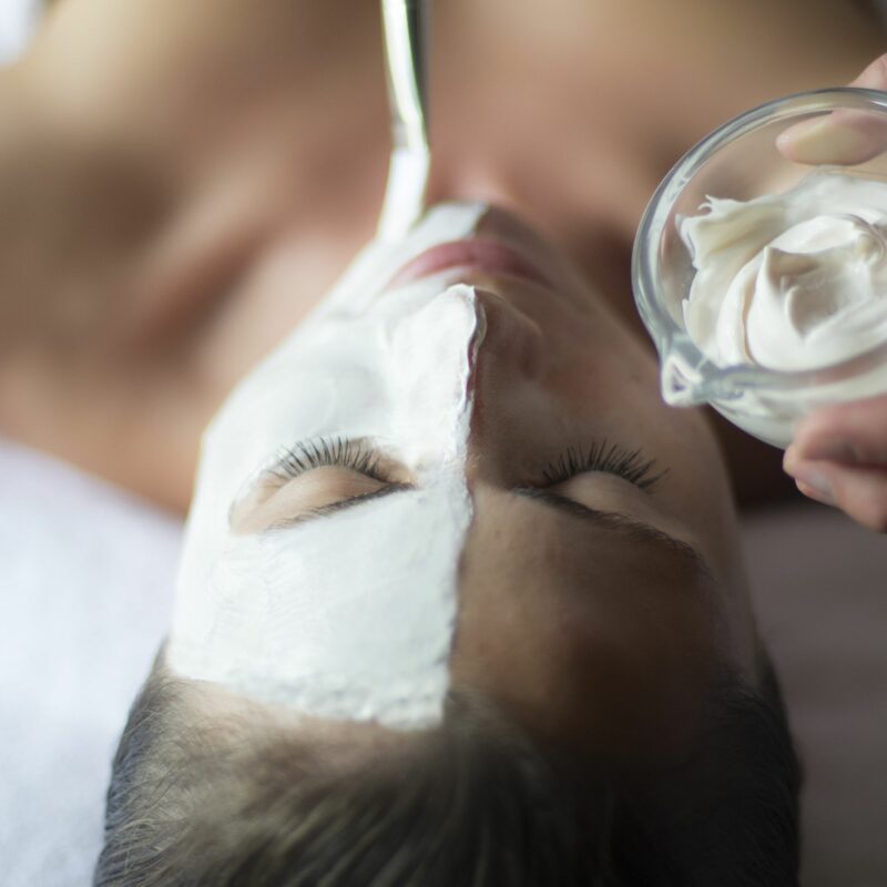 woman having face mask applied