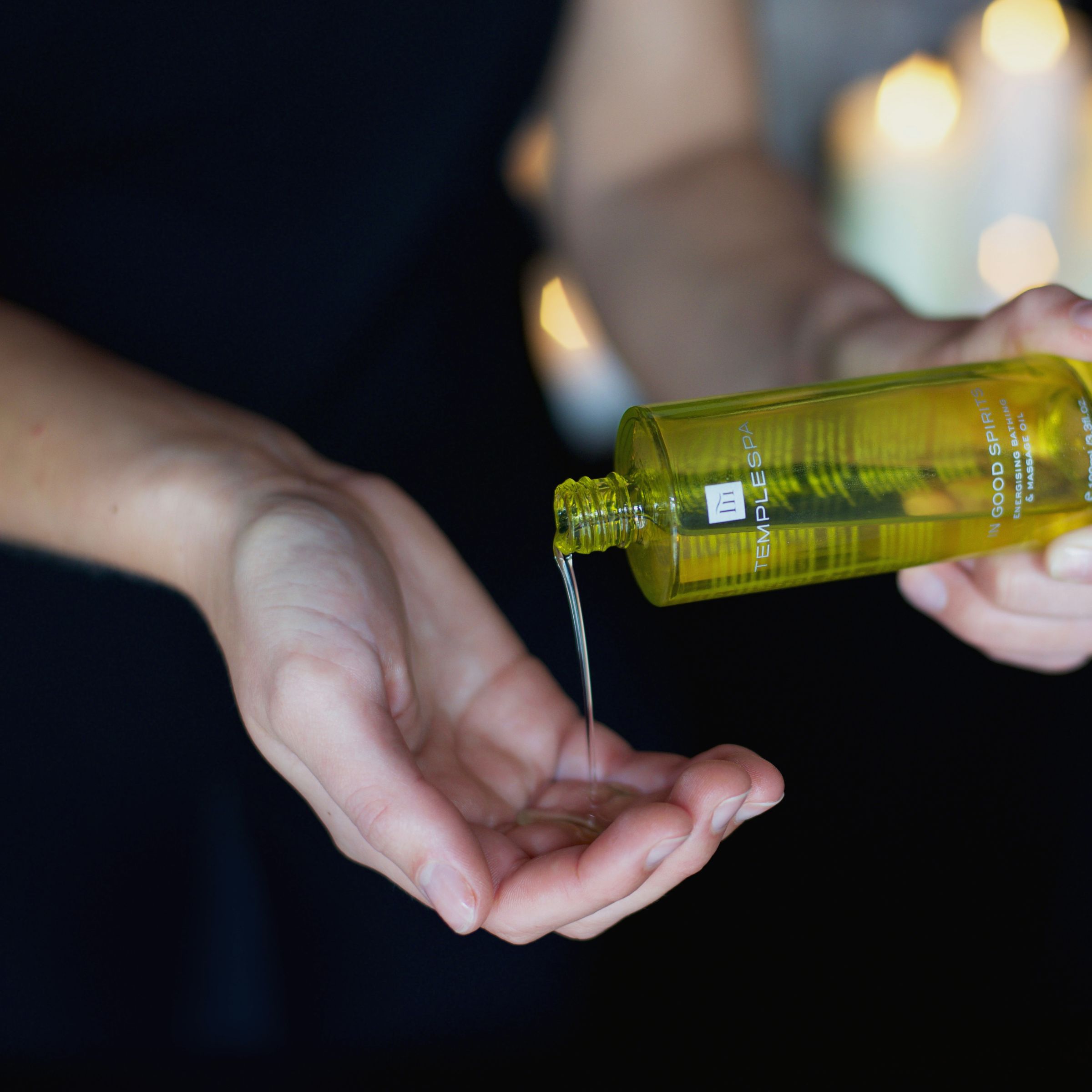 Woman pouring spa oil into hand at Bovey Castle spa 