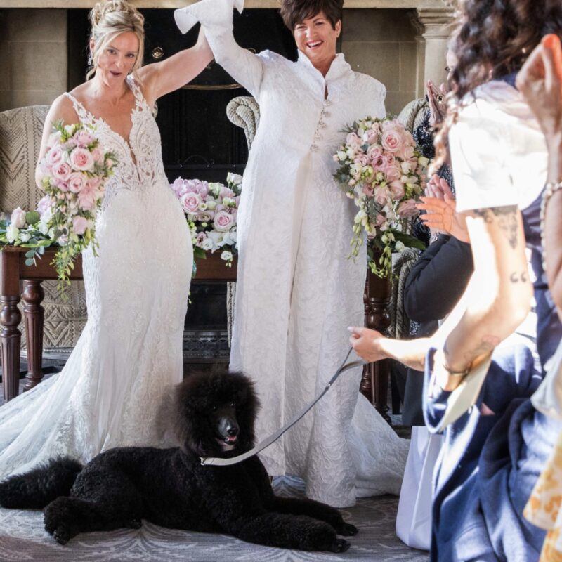 married couple raising their arms in celebration