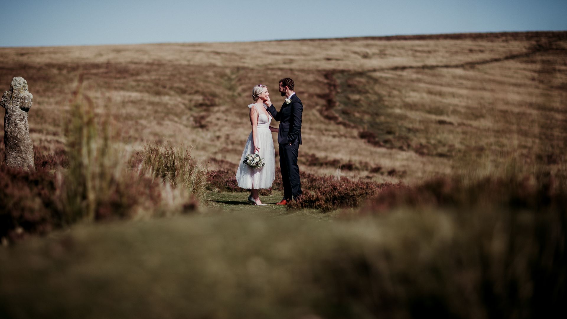 Married couple smiling at each other on Dartmoor 